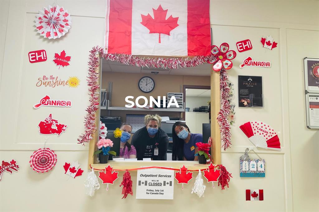 Sonia Ferrante and coworkers in front of decorated wall